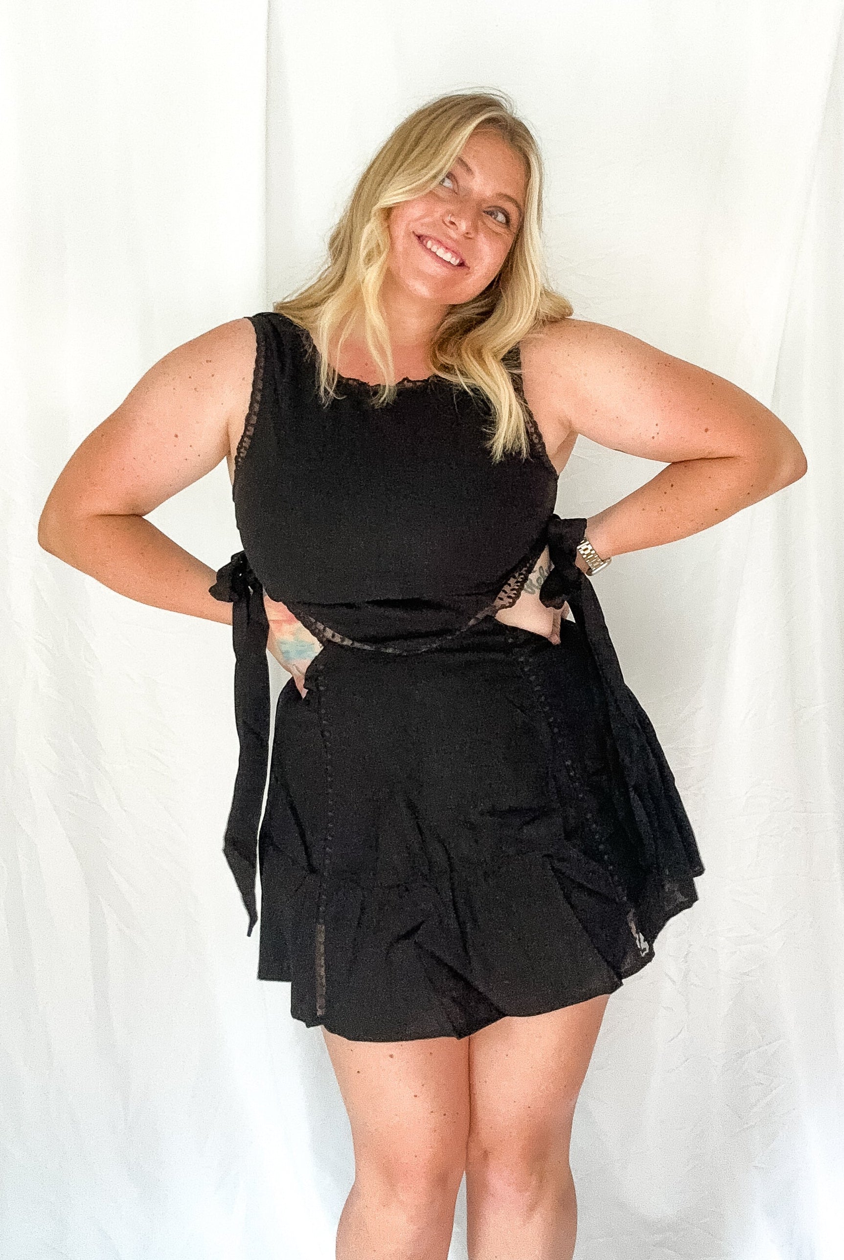 Woman wearing a black outfit against a white background