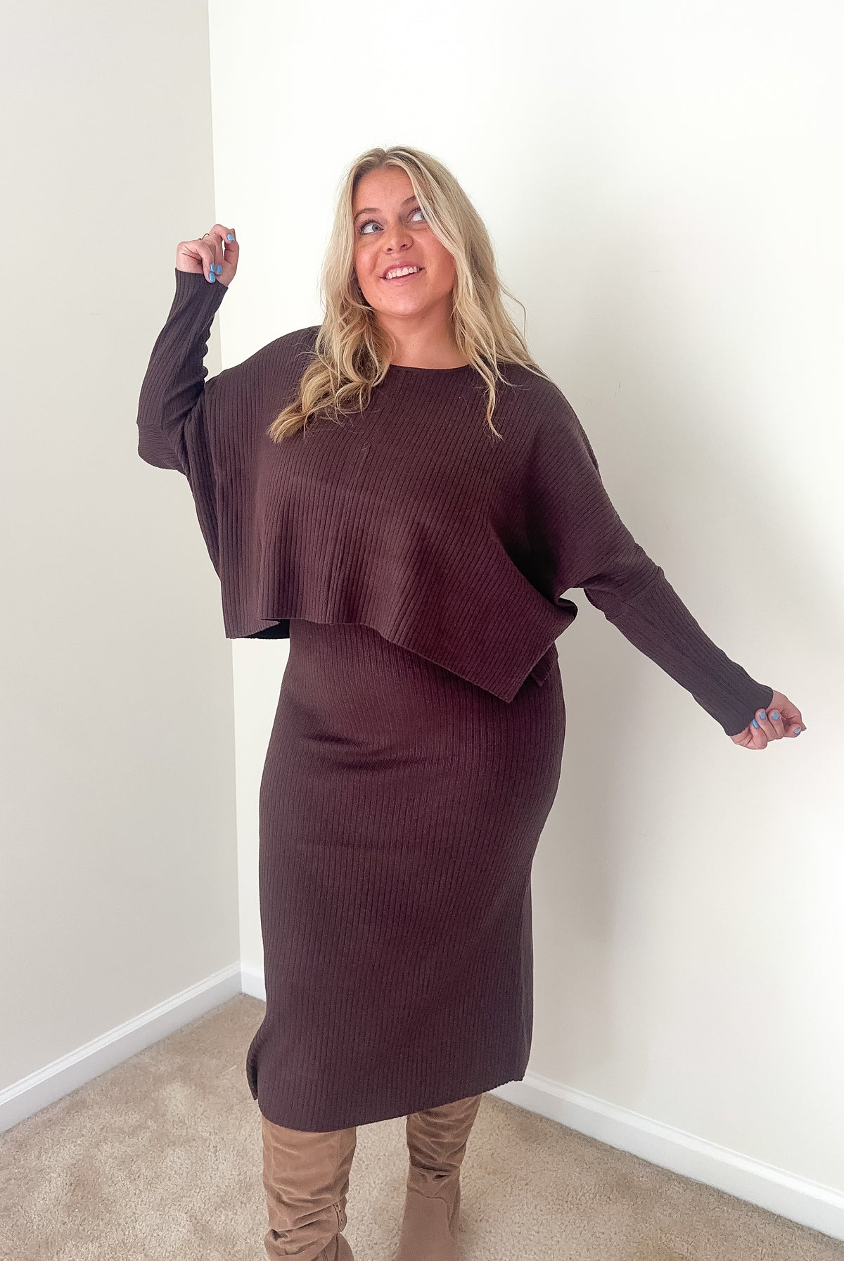 A woman wearing a dark mocha ribbed knit top and midi dress set.