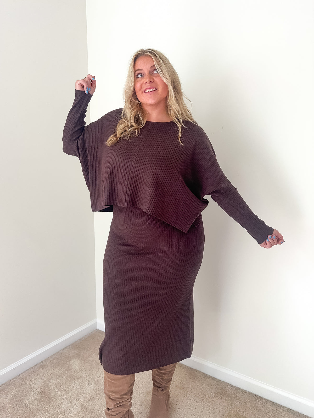 A woman wearing a dark mocha ribbed knit top and midi dress set.