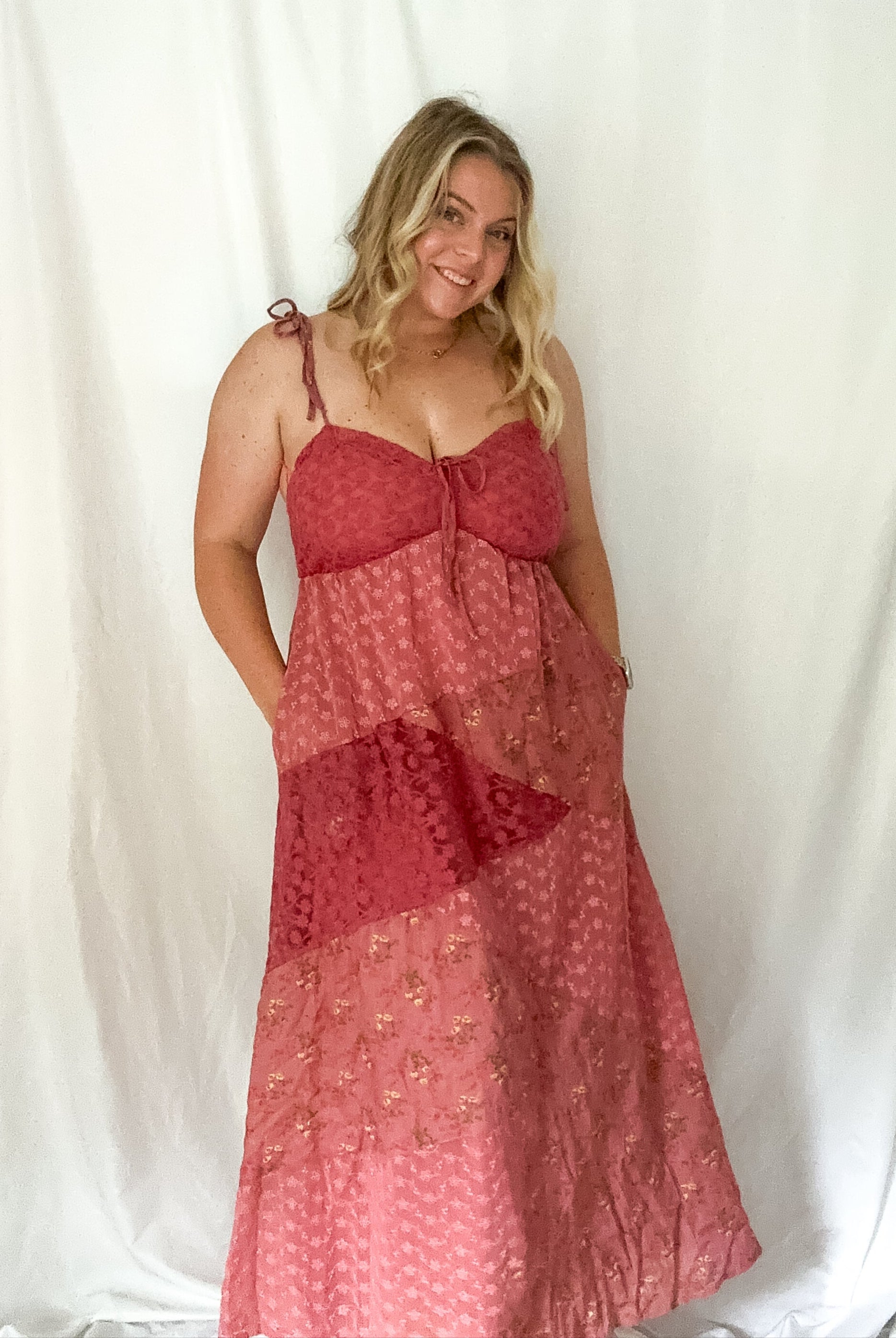 Woman wearing a red patterned dress against a white background