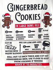 Person wearing a white sweatshirt with gingerbread cookies recipe design.