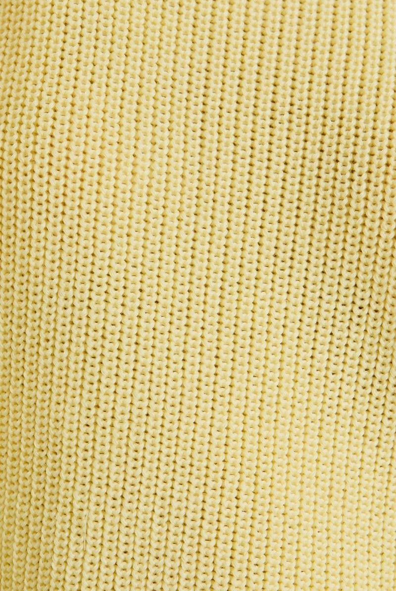 Close-up of a textured yellow fabric surface