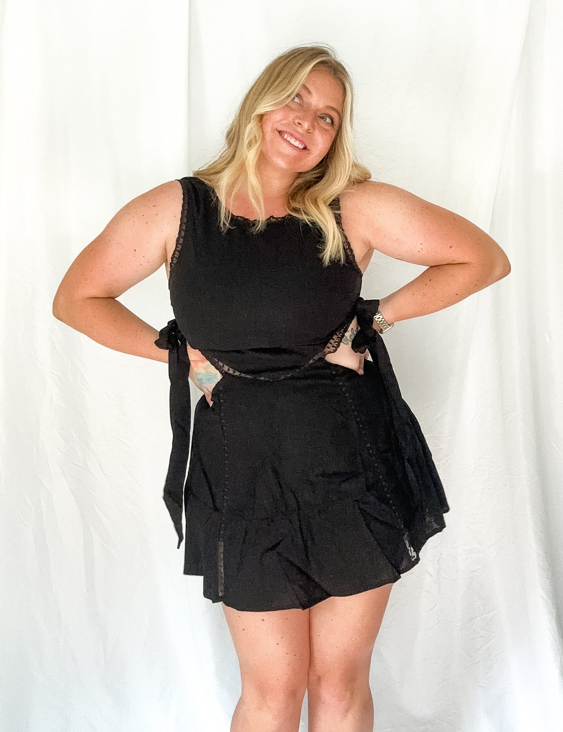 Woman wearing a black outfit against a white background