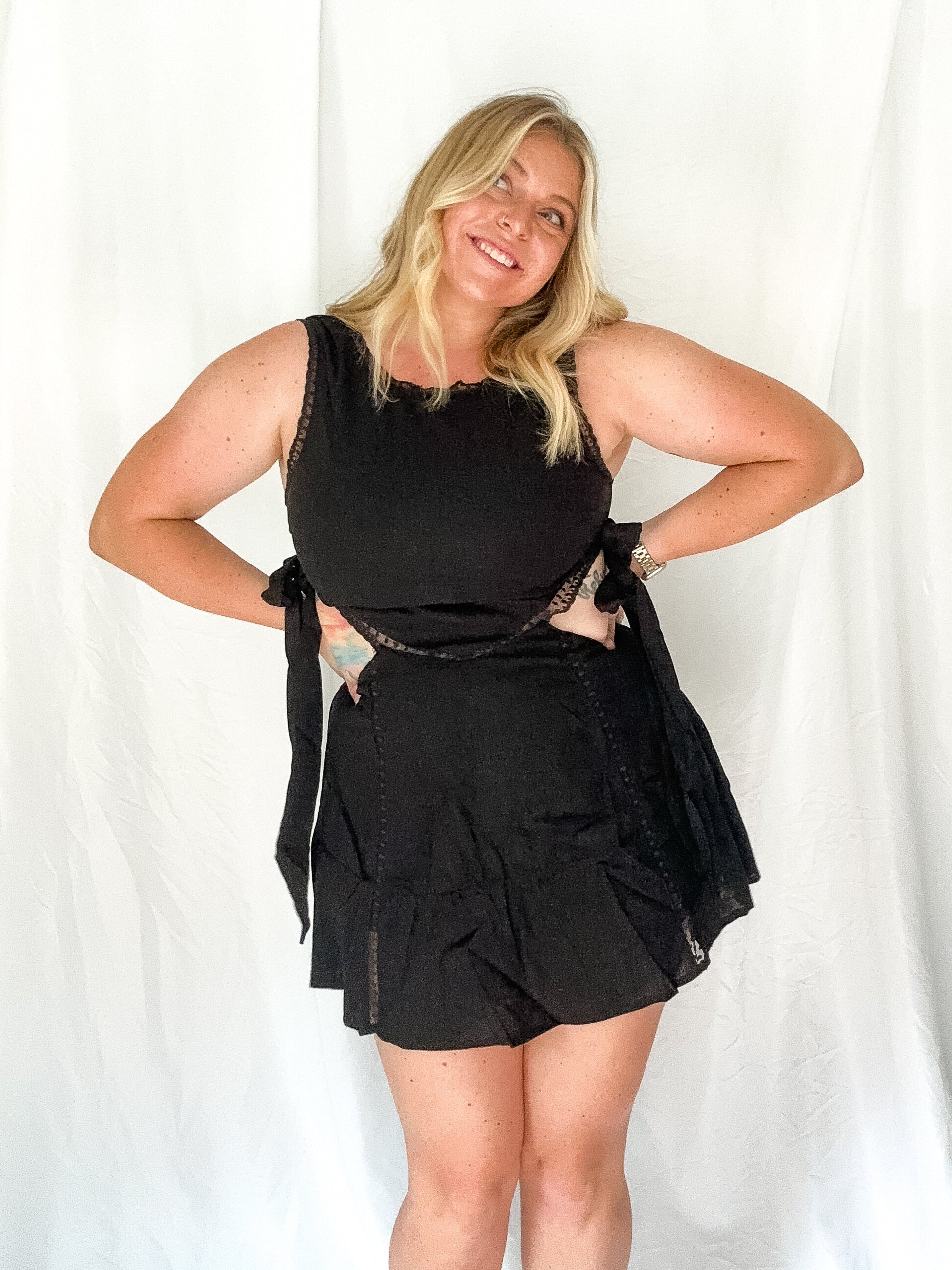 Woman wearing a black outfit against a white background
