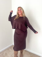 A woman wearing a dark mocha ribbed knit top and midi dress set.